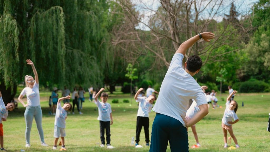 a group of people doing yoga in a park
